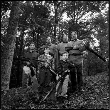 Photograph of Bob Lyon with sons Robert, Michael, and David and grandsons Craig and Ross, in woods wearing hunting garb.
