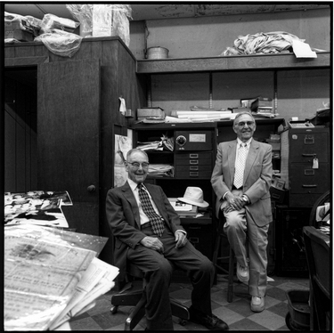 Photograph of Alwyn Goldstein and Philip Schneider in the back of Alwyn's store