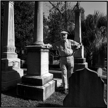 Photograph of Sol Breibart beside grave marker
